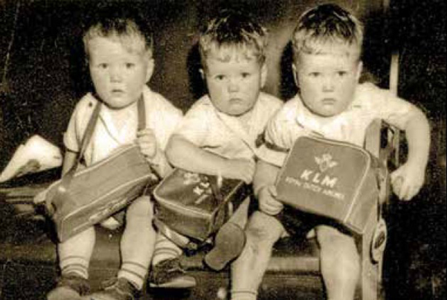 The triplets on their way to Canada with their KLM tote bags.
