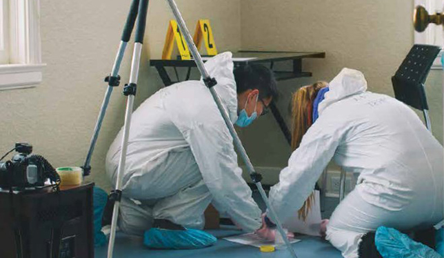 Students collect forensic evidence at the Crime Scene House at the University of Ontario Institute of Technology. Photo by Ian Patterson.