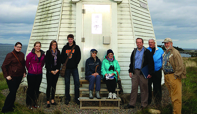 CBU students and local residents pose in front of the lighthouse with Dr. Urbaniak (third from right). 
