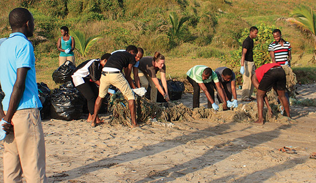 University of Victoria geography major and Queen Elizabeth Scholar Trilby Buck (brown shirt, centre) did a work term at the African Institute for Mathematical Sciences in Ghana from September to December 2015 – and also found time to help with local beach clean-up efforts. Photo by the University of Victoria.