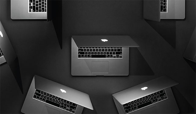 three grey apple laptops