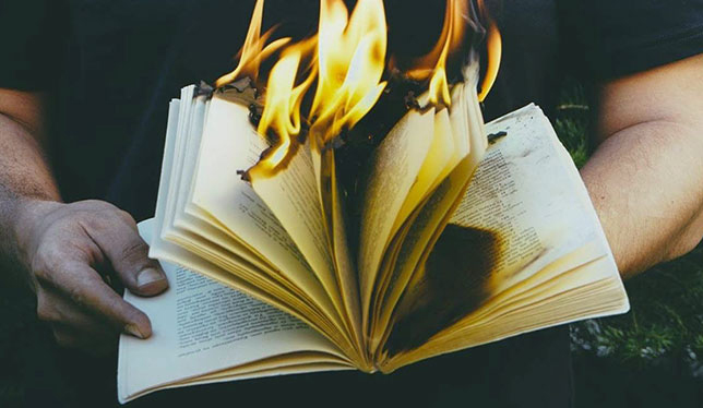 burning book in men hand